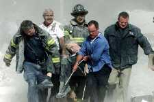 Firefighters remove the body of Rev. Mike
	   who was giving last rites to a victim when he
	   died